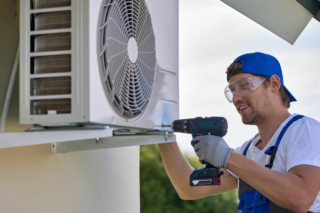 installer fixes air conditioner