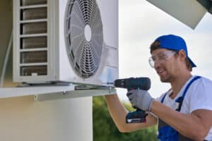 installer fixes air conditioner