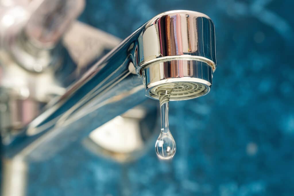 water drips from a leaky faucet